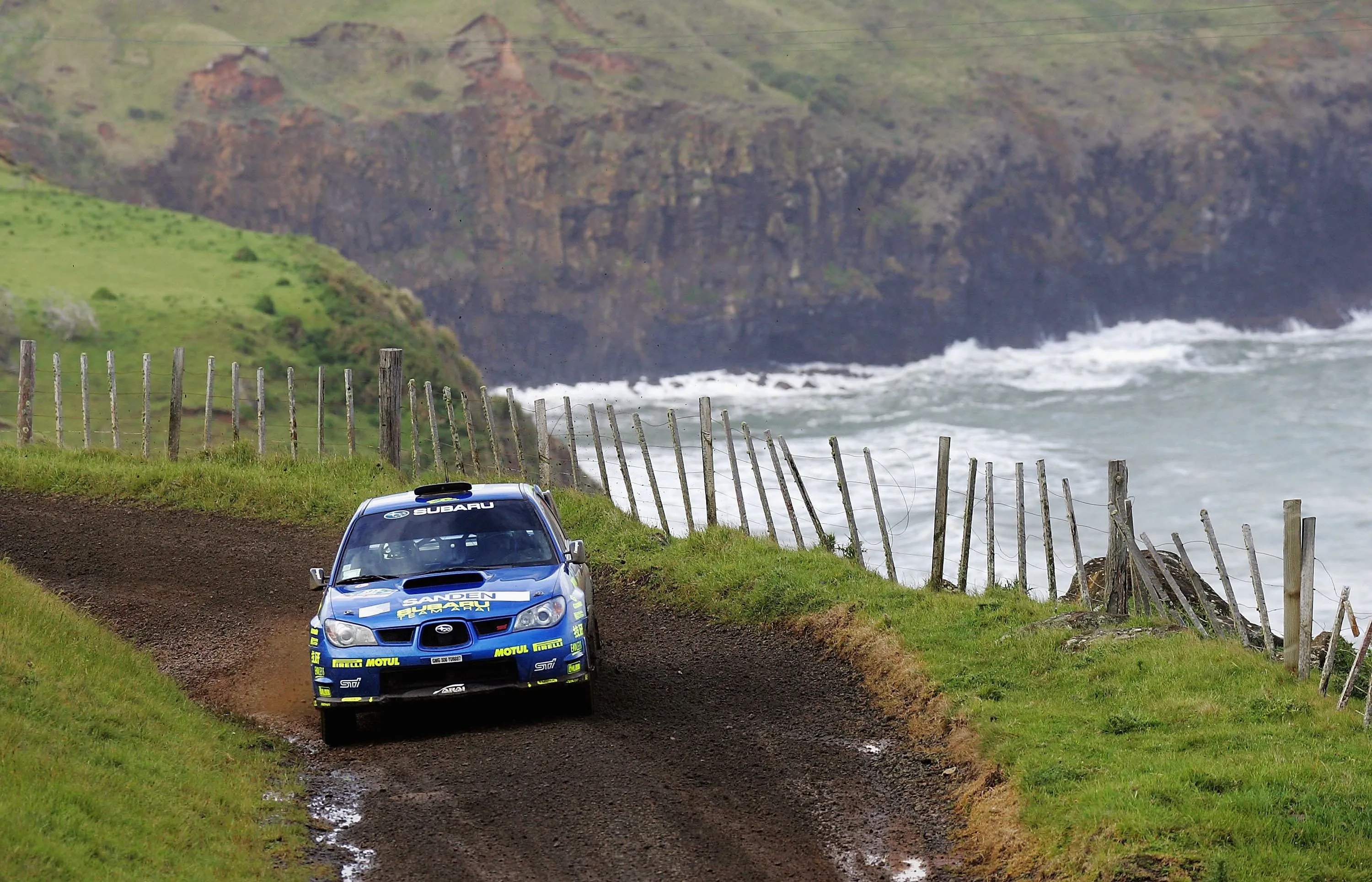 blue subaru with a landscape view