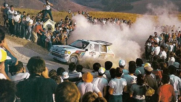 peugeot 205 drifting through crowd