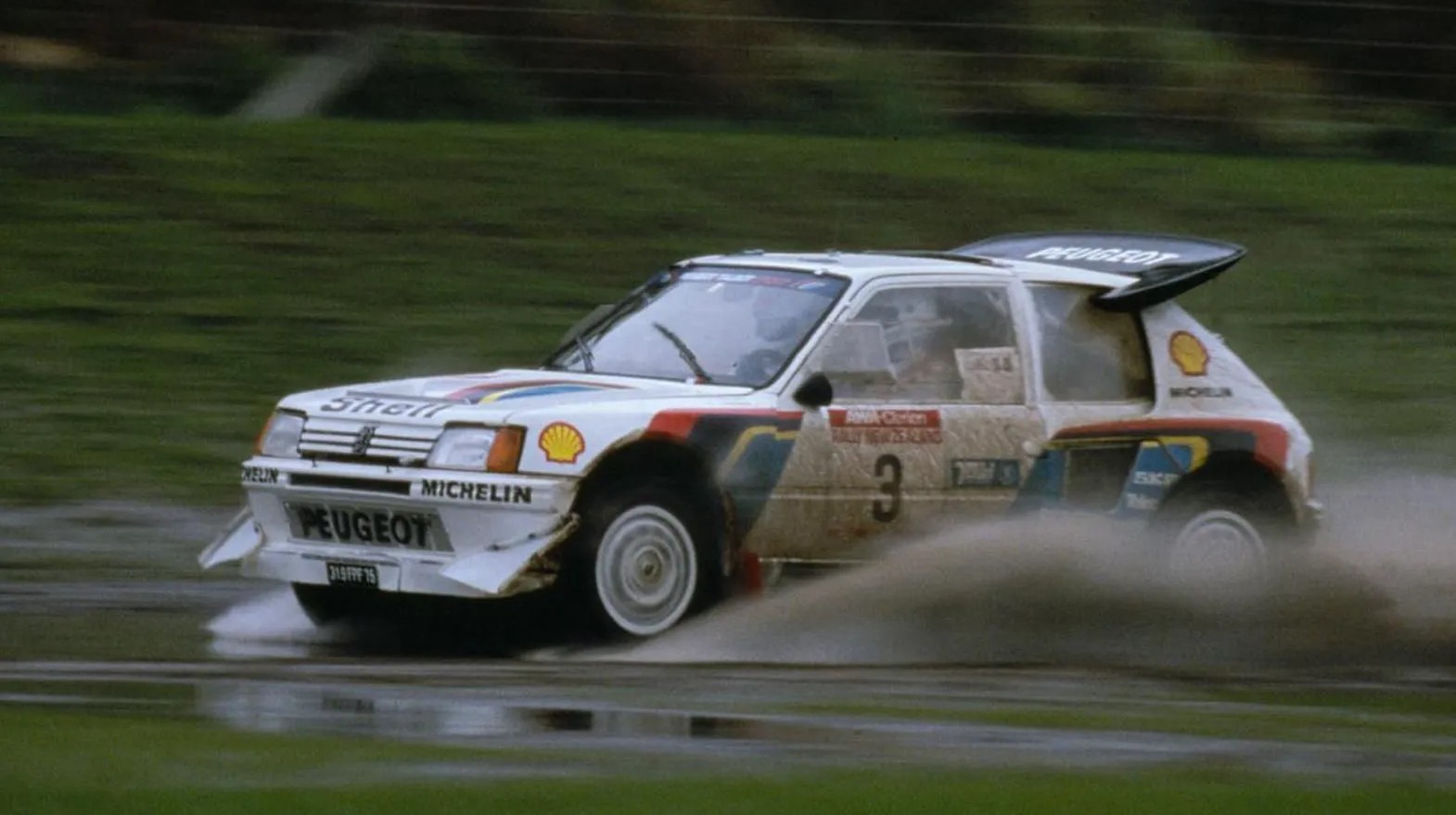 peugeot 205 passing through water splash